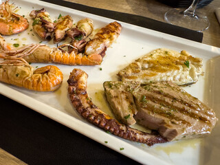 Assorted grilled seafood platter with shrimp, squid, fish, and octopus