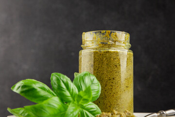 Pesto sauce basil, olive oil, parmesan, pine nuts, garlic natural product tasty snack fresh delicious gourmet food background on the table rustic top view copy space