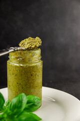 Pesto sauce basil, olive oil, parmesan, pine nuts, garlic natural product tasty snack fresh delicious gourmet food background on the table rustic top view copy space