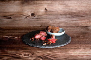 Strawberries with chocolate on a wooden background