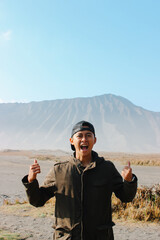 Excited Traveler Celebrating at Mount Bromo Volcano Landscape, Indonesia