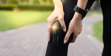 Close-up of woman holding her painful knee with glowing joint effect, showing signs of knee injury, joint pain, or arthritis. Concept of fitness injury, knee strain, and physical discomfort outdoors.
