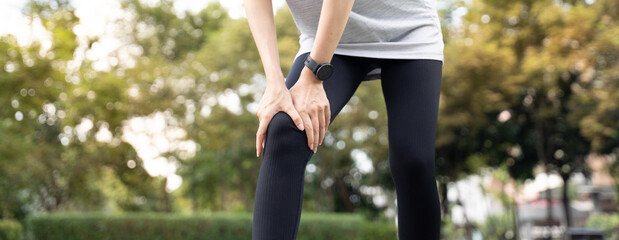 Close-up of woman holding her painful knee with glowing joint effect, showing signs of knee injury,...