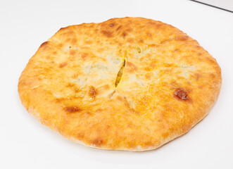 Golden Baked Georgian Kubdari With Flaky Crust And Meat Filling On White Plate
