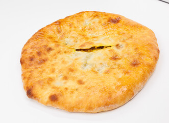 Golden Baked Georgian Kubdari With Flaky Crust And Meat Filling On White Plate
