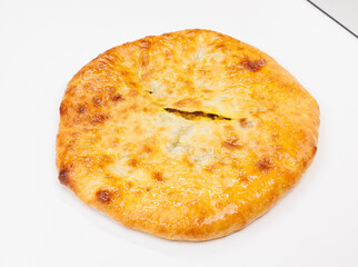 Golden Baked Georgian Kubdari With Flaky Crust And Meat Filling On White Plate