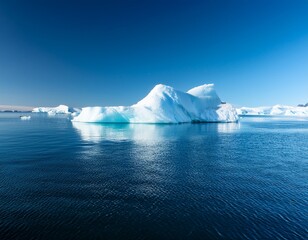 iceberg floating in calm blue water under a clear sky