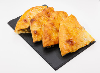 Four Golden Cheese and Meat Stuffed Flatbread Georgian Kubdari Slices on Slate Board