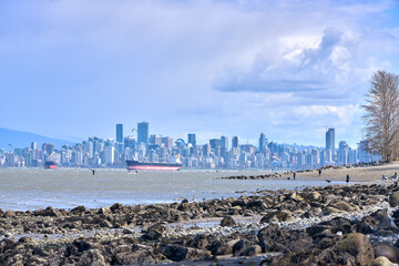 English Bay City Skyline Kite and Windsurfing. Kite and Windsurfers on English Bay on a blustery day. In the background is the downtown Vancouver Skyline.