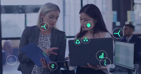 Two professional women flipping folder sparking growth energy icons in business meeting - Powered by Adobe