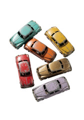 Six weathered vintage tinplate toy cars in faded colors, clustered on a transparent background with copy space, top-down view with soft lighting. Concept of nostalgic charm