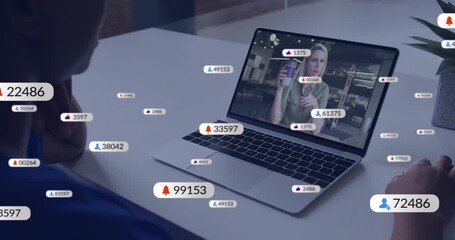 Viewer leaning on desk tracking host on laptop with floating engagement metrics showing growth - Powered by Adobe