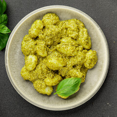 Gnocchi pesto sauce green tasty snack fresh gourmet food background on the table rustic top view copy space vegerian and vegan food