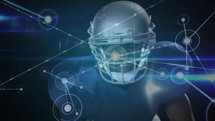 Football player leaning pre-snap as data node pulsing on helmet driving sports tech network overlay - Powered by Adobe