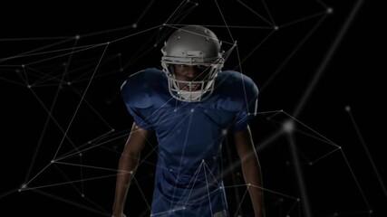 Male athlete stepping adjusting helmet while raising football showcasing network overlay technology - Powered by Adobe