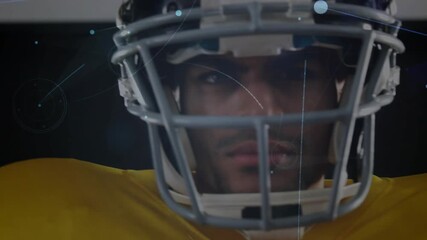 Football player staring into camera starting halo of particles around helmet showcasing sports tech - Powered by Adobe