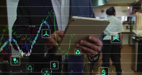 manager tapping tablet showing energy finance charts in kitchen reviewing data on sofa - Powered by Adobe