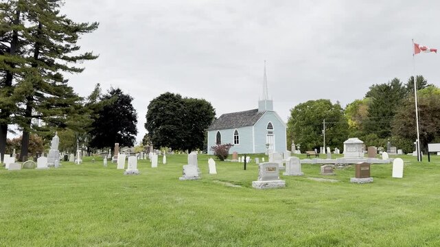 A blue church with a cemetery