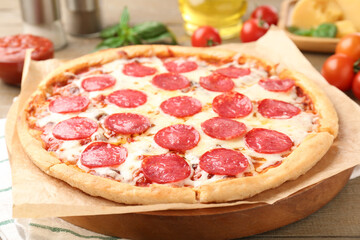 Delicious pepperoni pizza on wooden table, closeup
