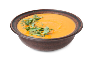 Delicious pumpkin soup with seeds and microgreens in bowl isolated on white
