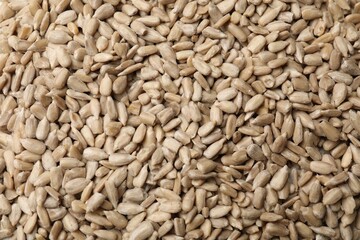 Peeled sunflower seeds as background, closeup view