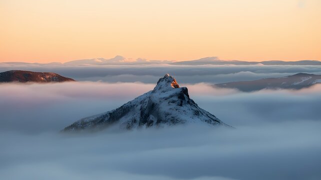 Majestic snow mountain at sunset with orange sky, perfect for travel agencies, winter posters, or inspirational landscape backgrounds