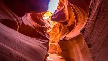 Deep sandstone canyon with light streaming through a narrow opening