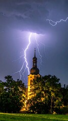 Church tower struck by powerful lightning during a night storm