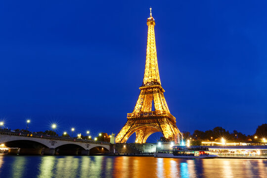 The view of the illuminated Eiffel Tower and the river Seine in Paris France