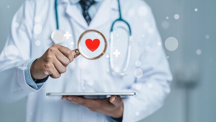 Doctor examines red heart symbol through magnifying glass over tablet device