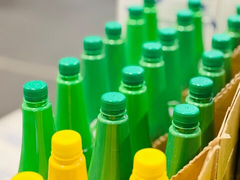 colorful plastic bottles. Close-up of many bottles of liquids on a store shelf. Many plastic bottles in a shop, caps close up.