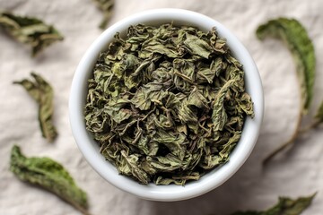 Fototapeta premium Dried herbs in a white bowl on a textured background showcasing culinary use and freshness