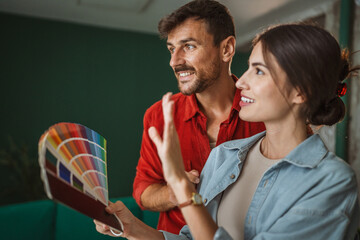 Couple choosing paint color for home renovation project