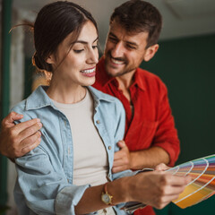 Couple choosing paint color for home renovation project