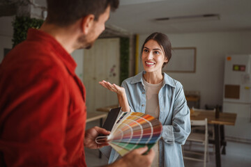 Interior designer showing color swatches to client during home renovation project
