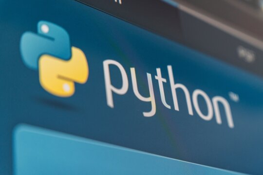 21 October 2025 - Tashkent, Uzbekistan: A detailed view of the Python programming logo displayed on a screen, showcasing the blue and yellow colors associated with the language.