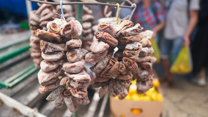Bunches of dried persimmons at a farmers' market. A traditional Abkhaz delicacy.