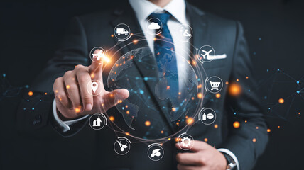A businessman interacting with a holographic globe surrounded by icons in a dark background