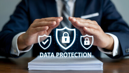 A businessman protecting data with hands over shields and padlocks in a security themed concept