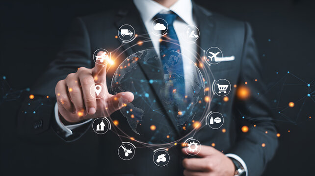 A businessman interacting with a holographic globe surrounded by icons in a dark background