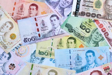 Thai baht currency money bills. The current banknotes lies on table in big amount close up
