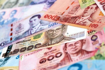 Thai baht currency money. The current banknotes lies on table in big amount close up