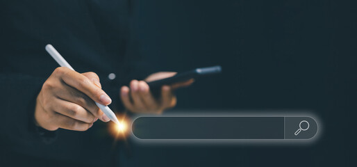 A businesswoman holding smartphone and stylus pen pointing at a search bar hologram, representing online search, digital marketing, data exploration, and internet research technology.