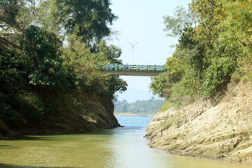 Green Hills and Sparkling Lake under Blue Sky