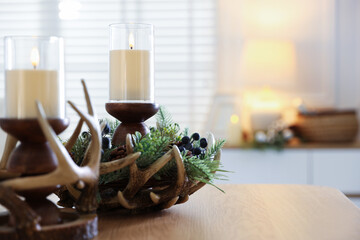 Beautiful LED candles and festive decor on wooden table indoors, closeup. Space for text