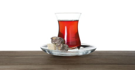 Traditional Turkish tea and dessert on wooden table against white background