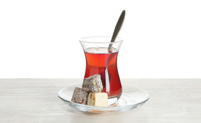 Traditional Turkish tea and delight on wooden table against white background