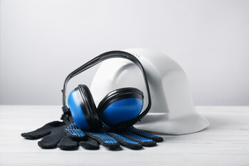 Different safety equipment on white wooden table