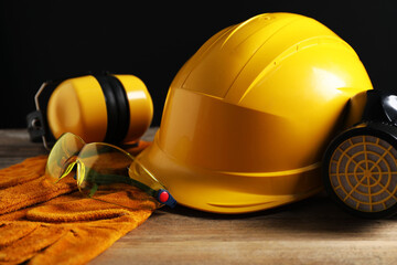 Different safety equipment on wooden table, closeup