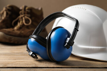 Different safety equipment on wooden table, selective focus.